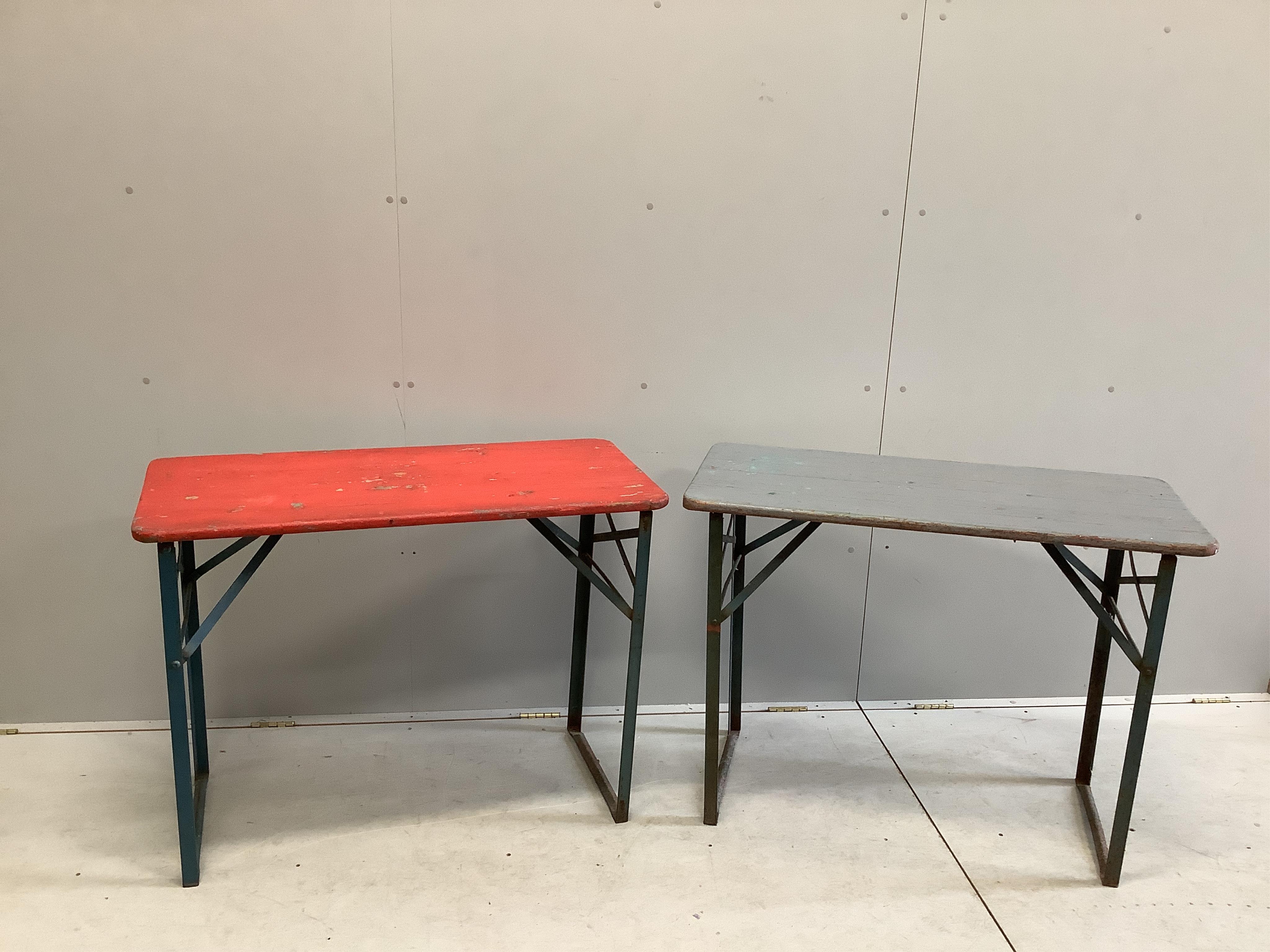 Two folding tables, width 103cm, depth 50cm, height 77cm, together with four red painted benches, with folding iron underframes. Condition - poor to fair